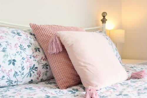 a bed with two pillows on top of it at Family Home, 20 mins from Youghal Beach in Killeagh