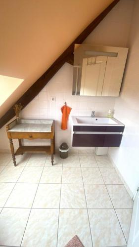 a bathroom with a sink in a attic at La ferme des chartreux in Messon