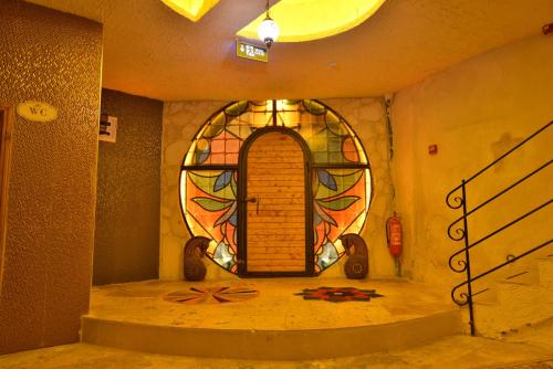 a room with a door with a stained glass window at Ashab-I Kehf Cappadocia House in Nevsehir