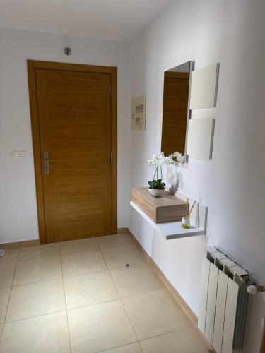 a kitchen with a door and a counter with flowers at Villa Arán in Negreira
