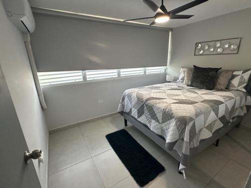 a bedroom with a bed and a ceiling fan at 3 Bedrooms Villa Close to Beaches and Atractions at Fajardo PR in Fajardo