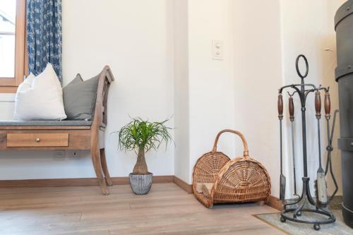 a living room with a bench and a basket at Chesa Michel in Bever