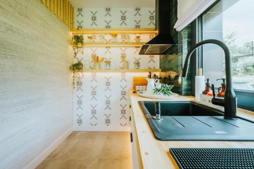 a kitchen with a sink and a window at Yama Krywe in Krywe