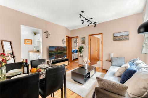 a living room with a couch and a table at Stylish 2 Bedroom Apartment in Chelsea in New York