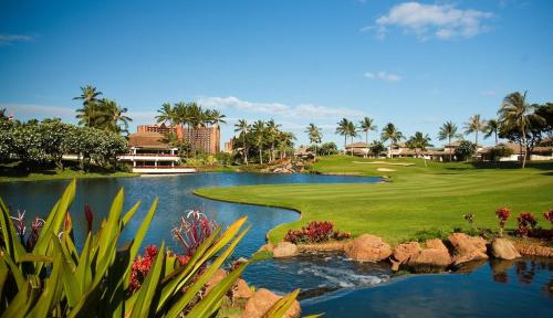 a view of a golf course with a pond at Relaxing Paradise Getaway in Kapolei
