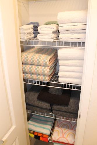 a closet filled with towels and folded towels at Relaxing Paradise Getaway in Kapolei