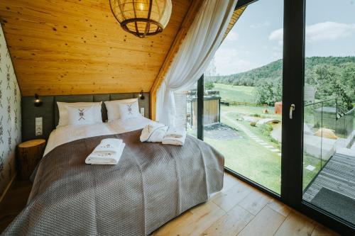 a bedroom with a large bed and a large window at Yama Krywe in Krywe