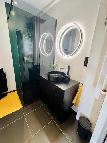 a bathroom with a sink and a mirror at Apartament Panorama Żory in Żory