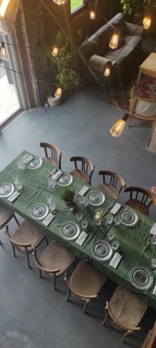 a table with chairs and a green table cloth at Idzikówka 