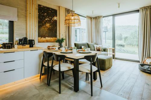 a kitchen and living room with a table and chairs at Yama Krywe in Krywe