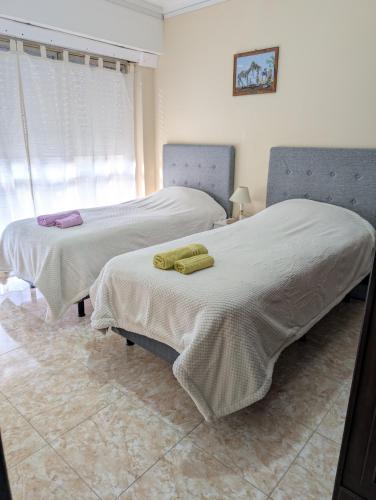 two beds sitting next to each other in a room at Centro House Departamento de tres dormitorios in Santa Fe