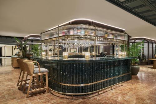a bar in a building with a large glass at The Millen Penang, Autograph Collection in George Town