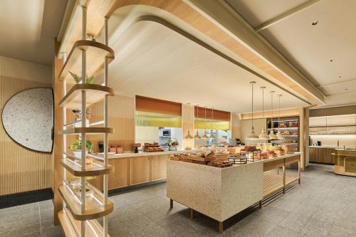 a large kitchen with a counter in the middle at The Millen Penang, Autograph Collection in George Town