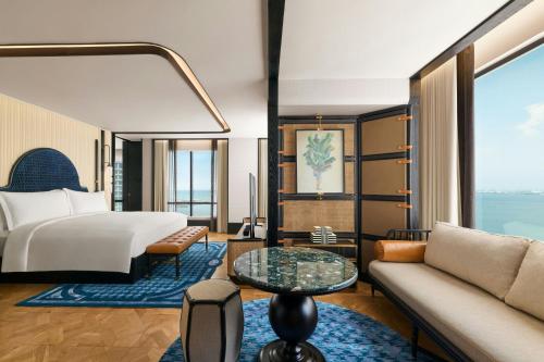 a hotel room with a bed and a couch at The Millen Penang, Autograph Collection in George Town