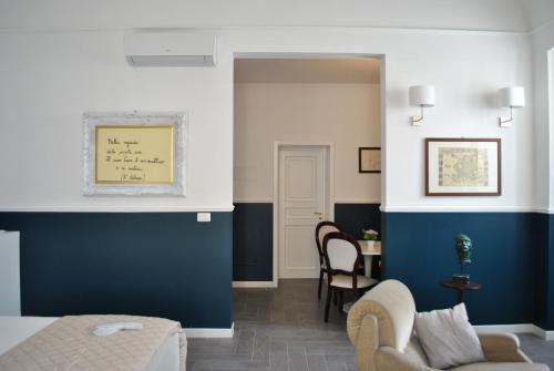 a bedroom with blue and white walls and a living room at Novecento Dimore di Poesia in Trani
