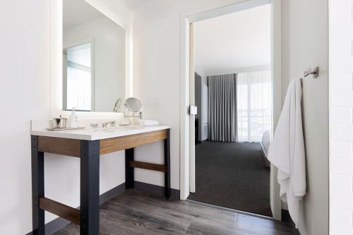a bathroom with a sink and a mirror at Archer Hotel Boston/Burlington in Burlington