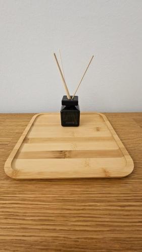 a wooden cutting board with chop sticks in it at bookVienna "JiM" Apartments in Vienna