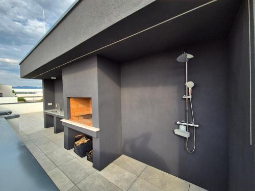 a bathroom with a shower and a fireplace at Villa Restart Vrsi-Mulo in Vrsi