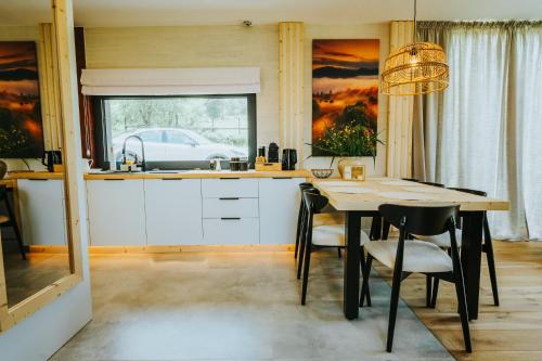 a kitchen with a table and chairs and a window at Yama Krywe in Krywe