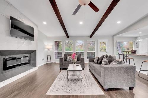 a living room with two couches and a fireplace at Serene Deck 10 Mins Garland City Square in Garland
