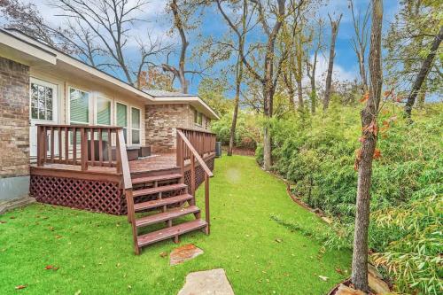 a house with a wooden staircase in a yard at Serene Deck 10 Mins Garland City Square in Garland