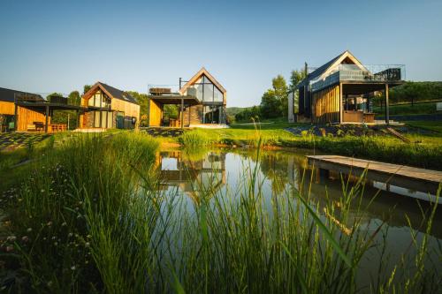 a group of houses next to a body of water at Yama Krywe in Krywe