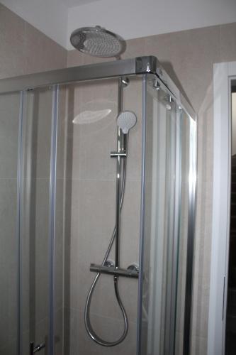 a shower in a bathroom with a shower curtain at Wiki in Vodice