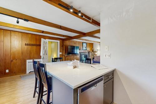 a kitchen with a white counter top and wooden ceilings at Topside Garden in North Conway