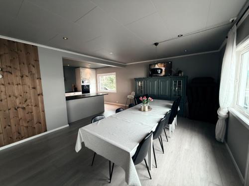 a dining room with a long table and chairs at Full house with stunning view near Pulpit rock in Jørpeland