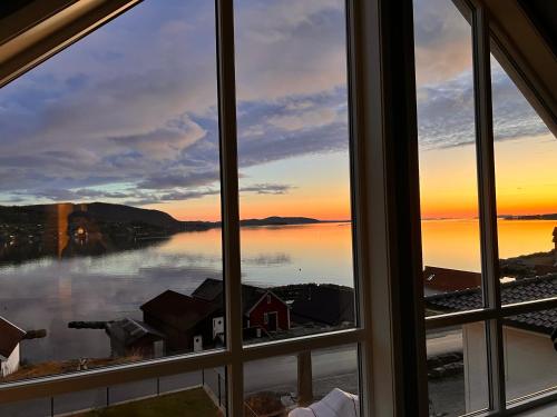 an open window with a view of the water at Full house with stunning view near Pulpit rock in Jørpeland