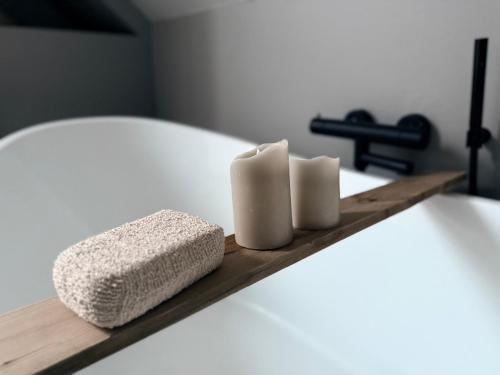 a shelf with two towels and two candles on a bed at Full house with stunning view near Pulpit rock in Jørpeland