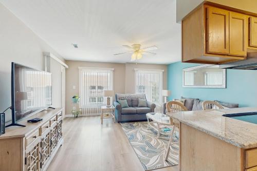 a kitchen and living room with a couch and a table at Suite Retreat in Emerald Isle