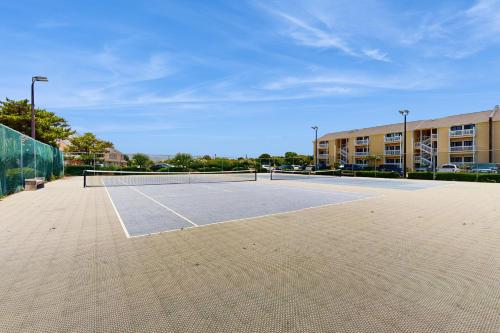 a tennis court with two tennis rackets on it at Suite Retreat in Emerald Isle