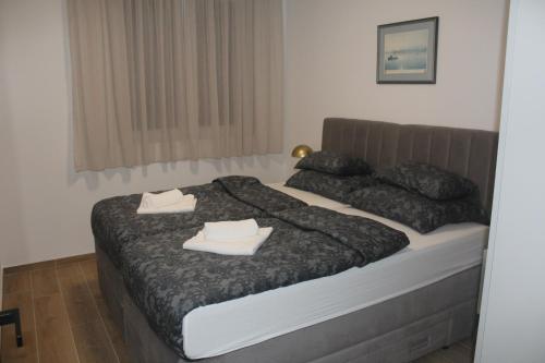 a bedroom with a bed with two towels on it at Wiki in Vodice
