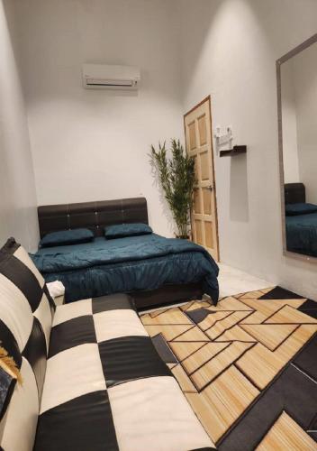 a bedroom with a bed and a mirror at Sun Rimba Home by Ipoh Maju Stay in Ipoh