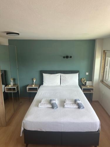 a bedroom with a large bed with two pillows on it at Coastal Escape in Kavala