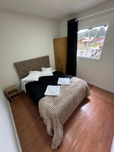 a bedroom with a bed and a large window at Container 260 in Cambará