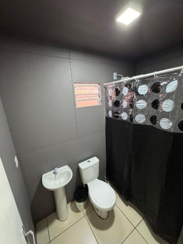 a bathroom with a toilet and a sink at Container 260 in Cambará