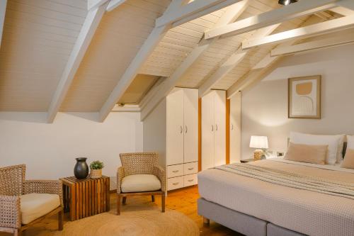 a bedroom with a bed and two chairs at Theros Retreat in Spartia