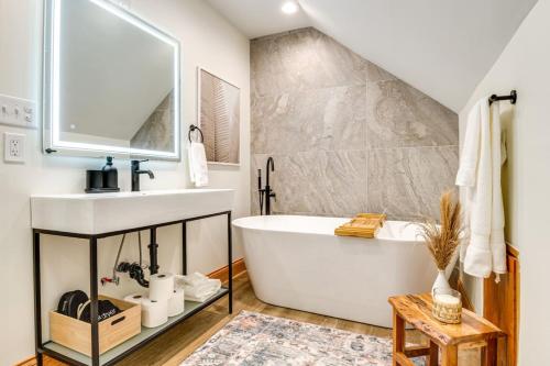 a bathroom with a white tub and a sink at Skyline View Condo Best downtown spot Park FREE in Indianapolis