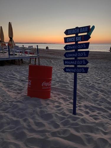 a sign in the sand on a beach at APART PARK -Lividus112 in Świnoujście