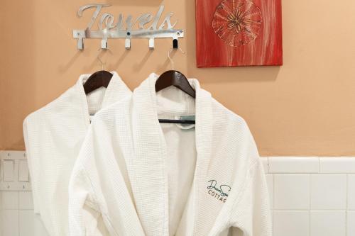 a white sweater hanging on a rack in a bathroom at DreamSpace Estate, Private Luxury Villa, Pool, Car and Beach in Nassau
