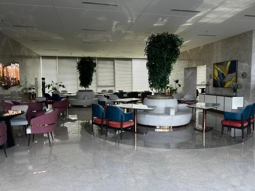 a restaurant with tables and chairs in a lobby at Atithi Dream Studios in Gurgaon