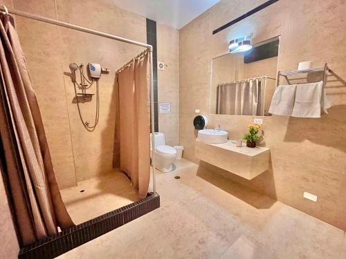 a bathroom with a shower and a toilet and a sink at Aryia Máncora in Máncora