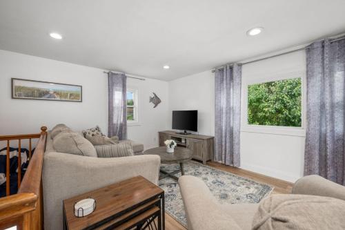 a living room with a couch and a tv at 7 Bodfish Avenue Sandwich - Life's A Beach! in Sandwich