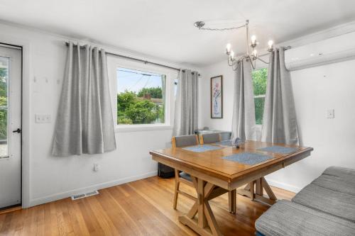 a dining room with a wooden table and a window at 7 Bodfish Avenue Sandwich - Life's A Beach! in Sandwich