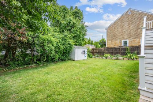 a yard with a fence and a house at 7 Bodfish Avenue Sandwich - Life's A Beach! in Sandwich