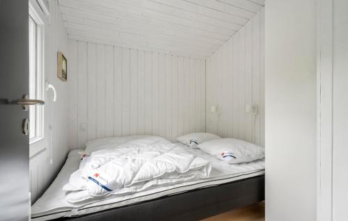 a bed in a room with white sheets and pillows at Amazing Home In Skjern With Wifi in Skjern