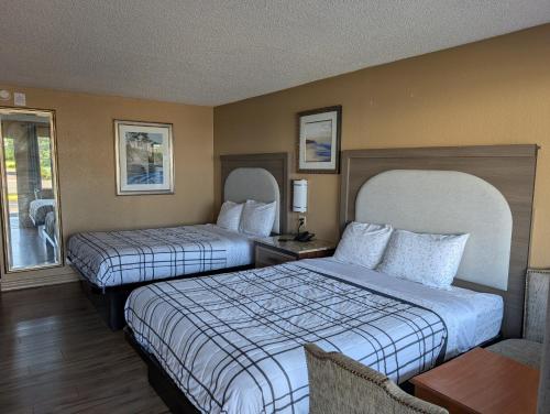 a hotel room with two beds and a window at Express INN in Norfolk