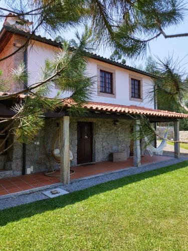 a house with a courtyard in front of it at Casa do Costeiro by AlmaStay in Gondufe